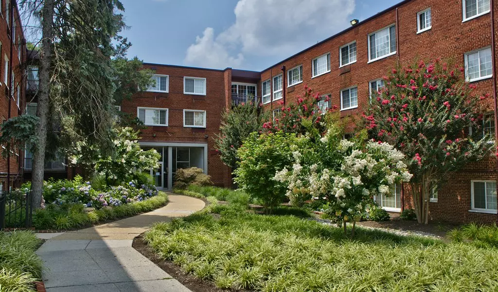 The Rockford Apartments courtyard entrance with landscaped gardens and brick exterior